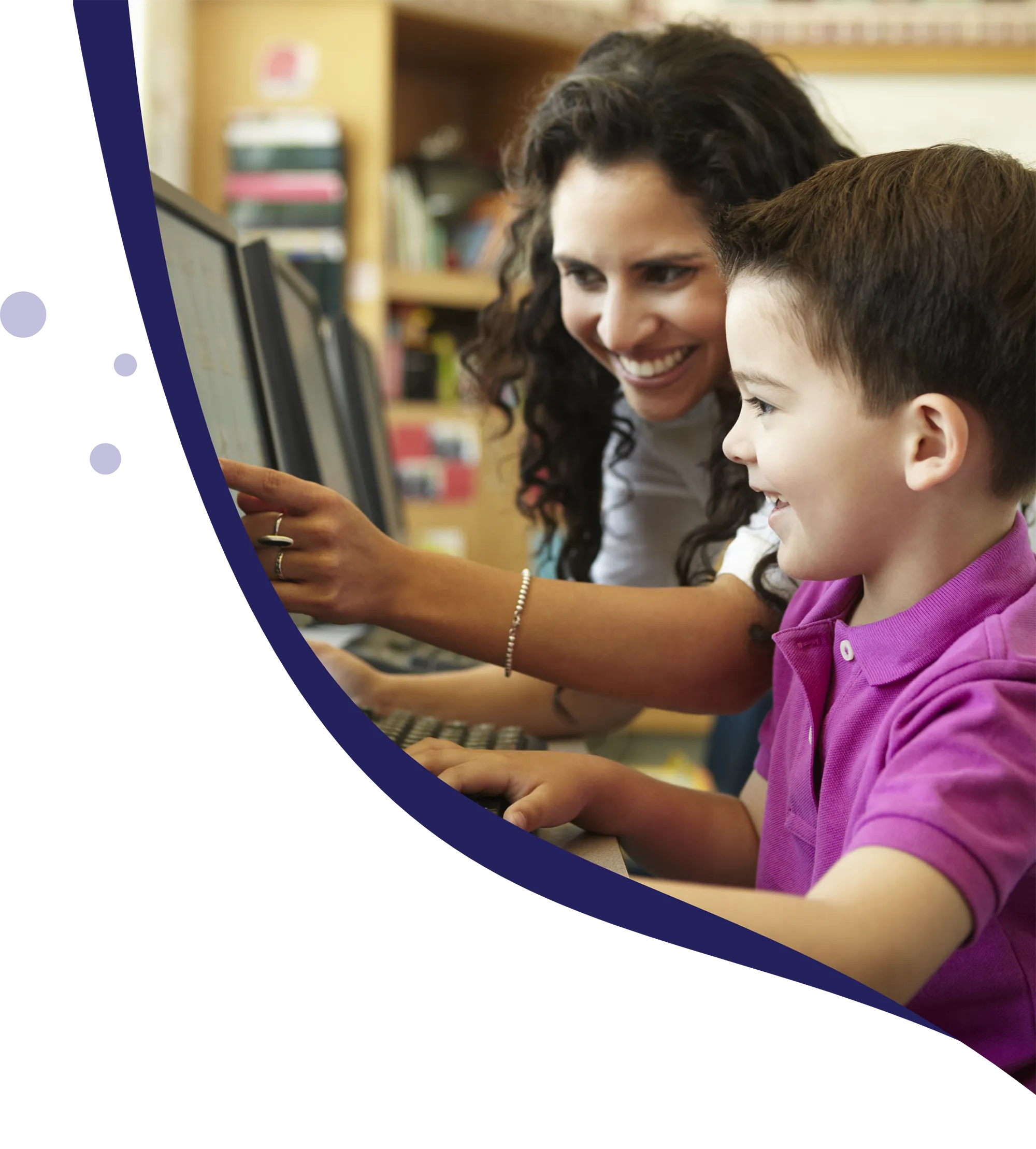 Teacher and student in classroom with computers